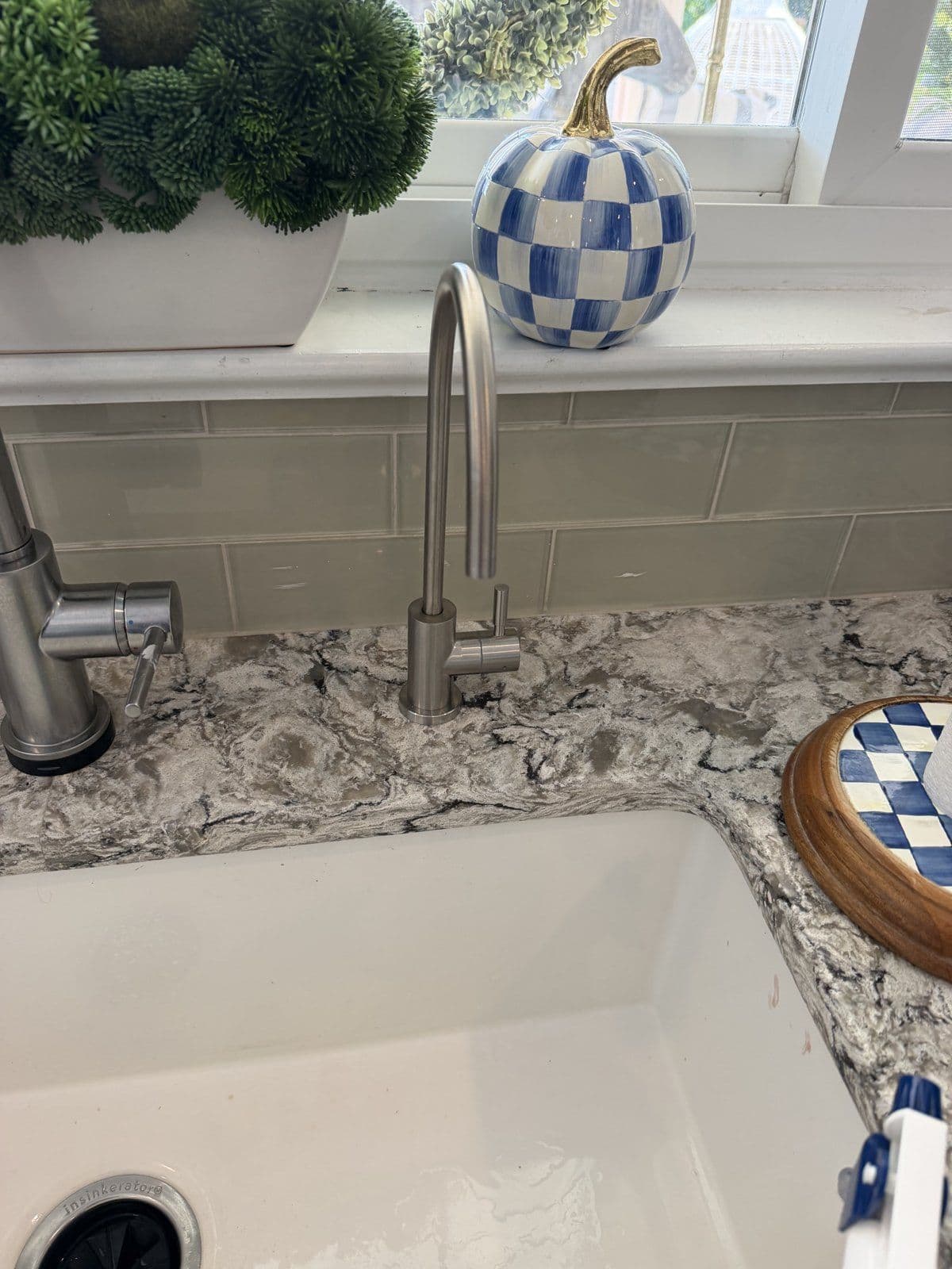 The Hydra's brushed steel faucet beside the main tap on a granite counter