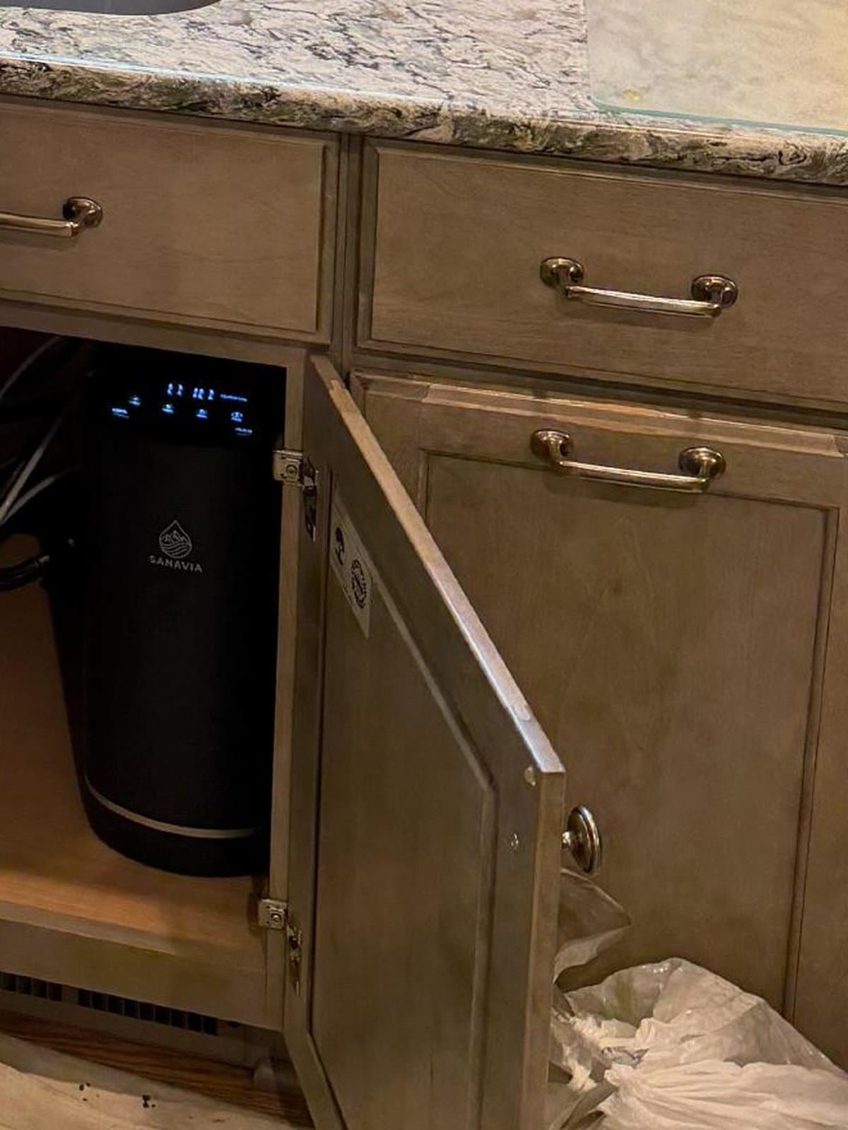 The Hydra installed in the cabinet under Priscilla's granite kitchen counter, door open
